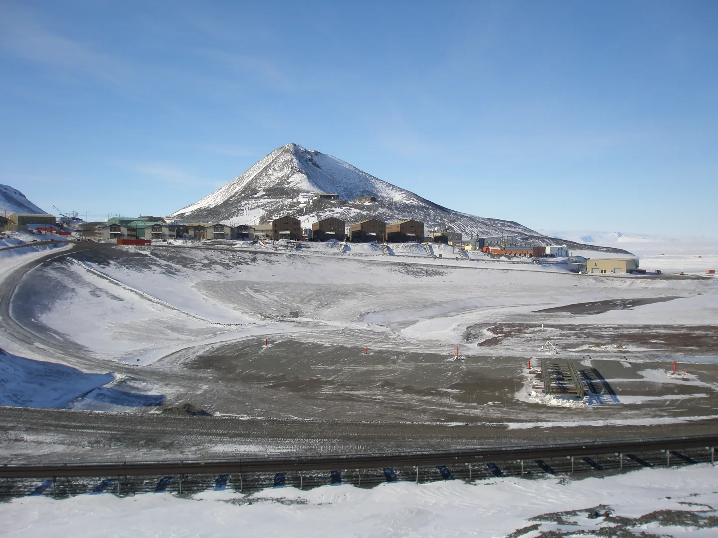 McMurdo station buildings and roads below dark volcanic ridges