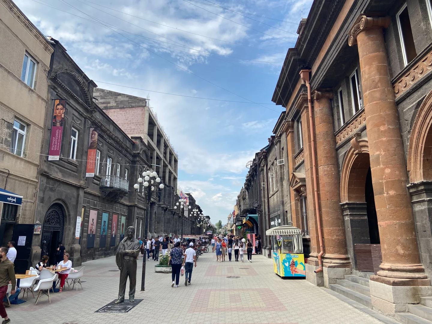 Pedestrians and stone-fronted buildings along Abovyan Street in Gyumri