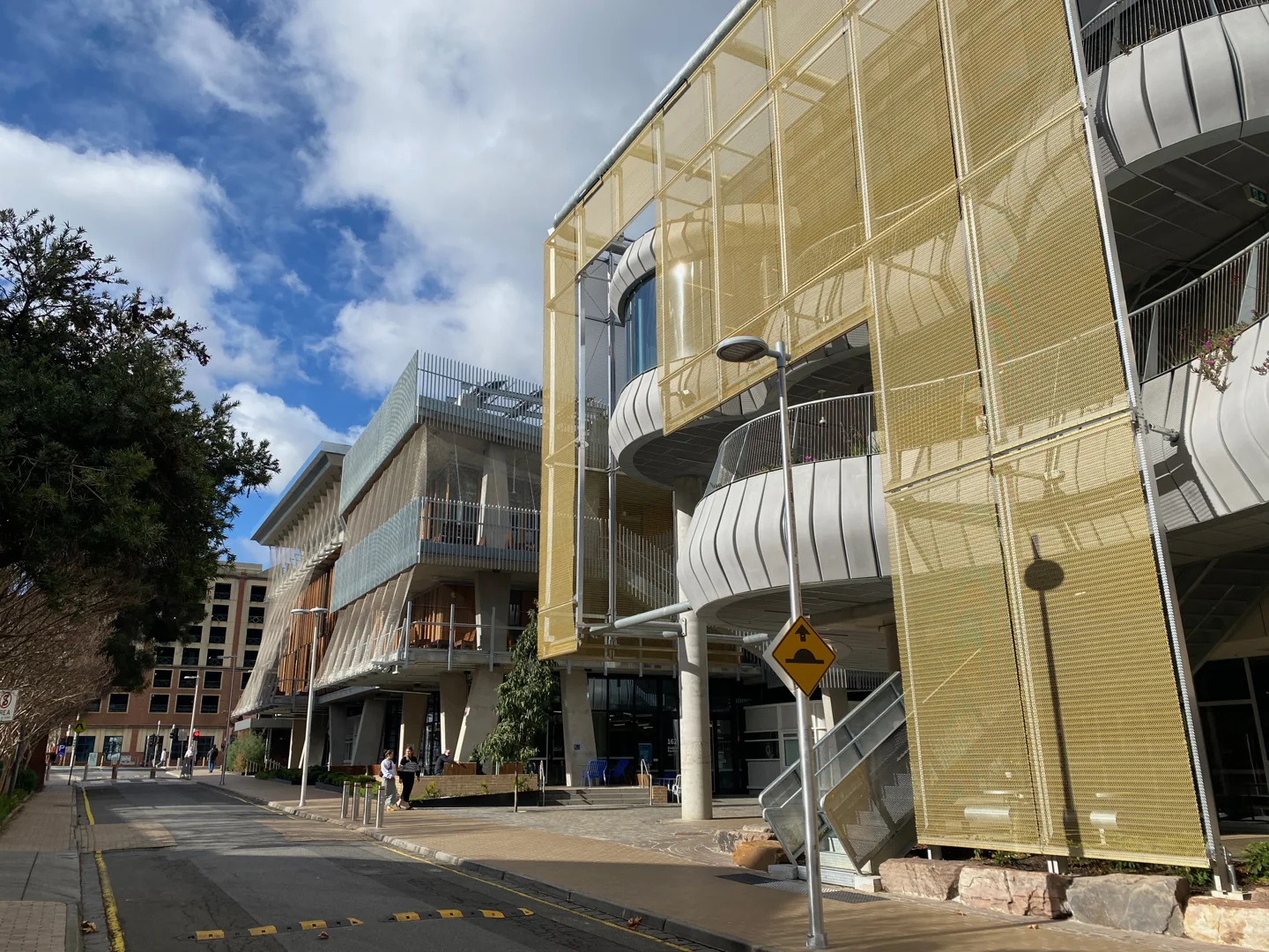 Contemporary campus buildings with balconies along Monash Road at the University of Melbourne