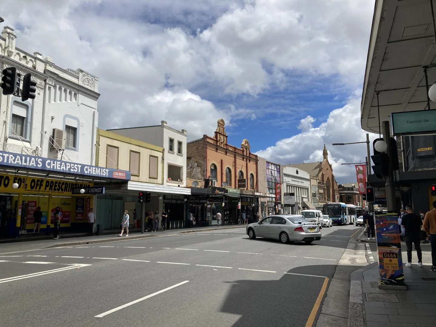 Shopfronts, traffic and pavement along King Street in Newtown Sydney
