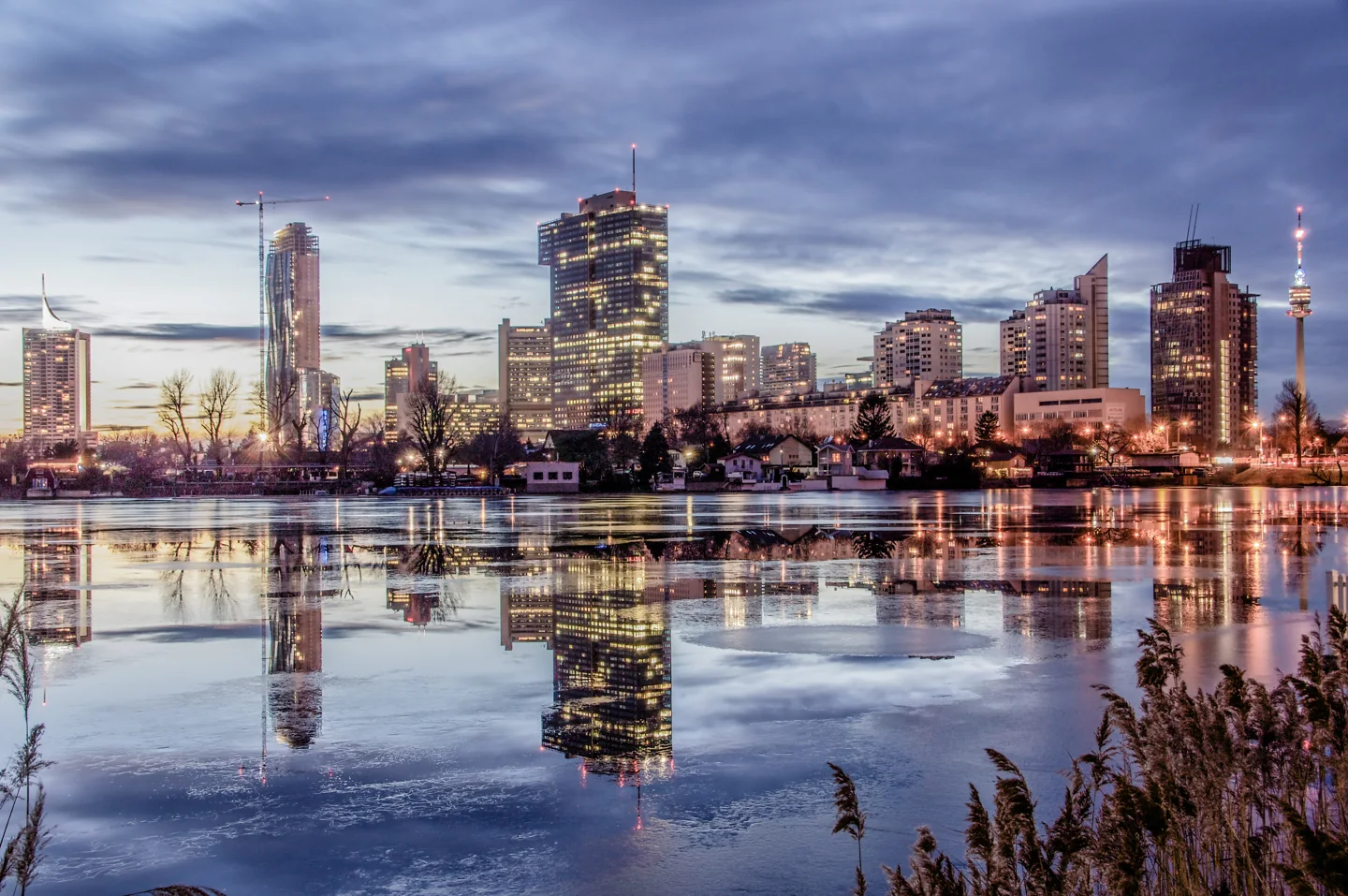 Vienna skyline reflected in the Alte Donau at dusk