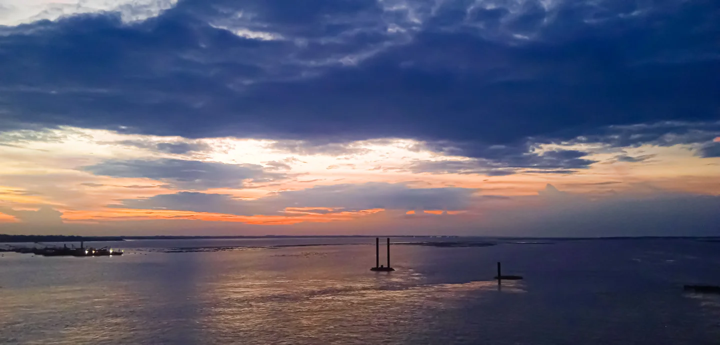 Jamuna River in Bangladesh beneath a cloudy sunset sky