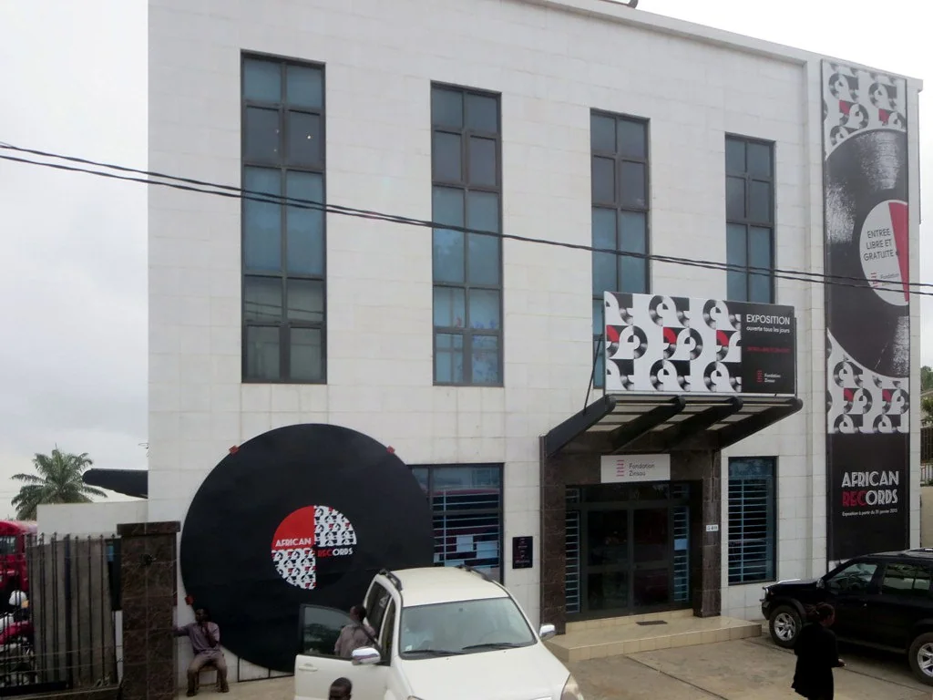 White Fondation Zinsou gallery facade with exhibition banners and an entrance canopy in Cotonou.