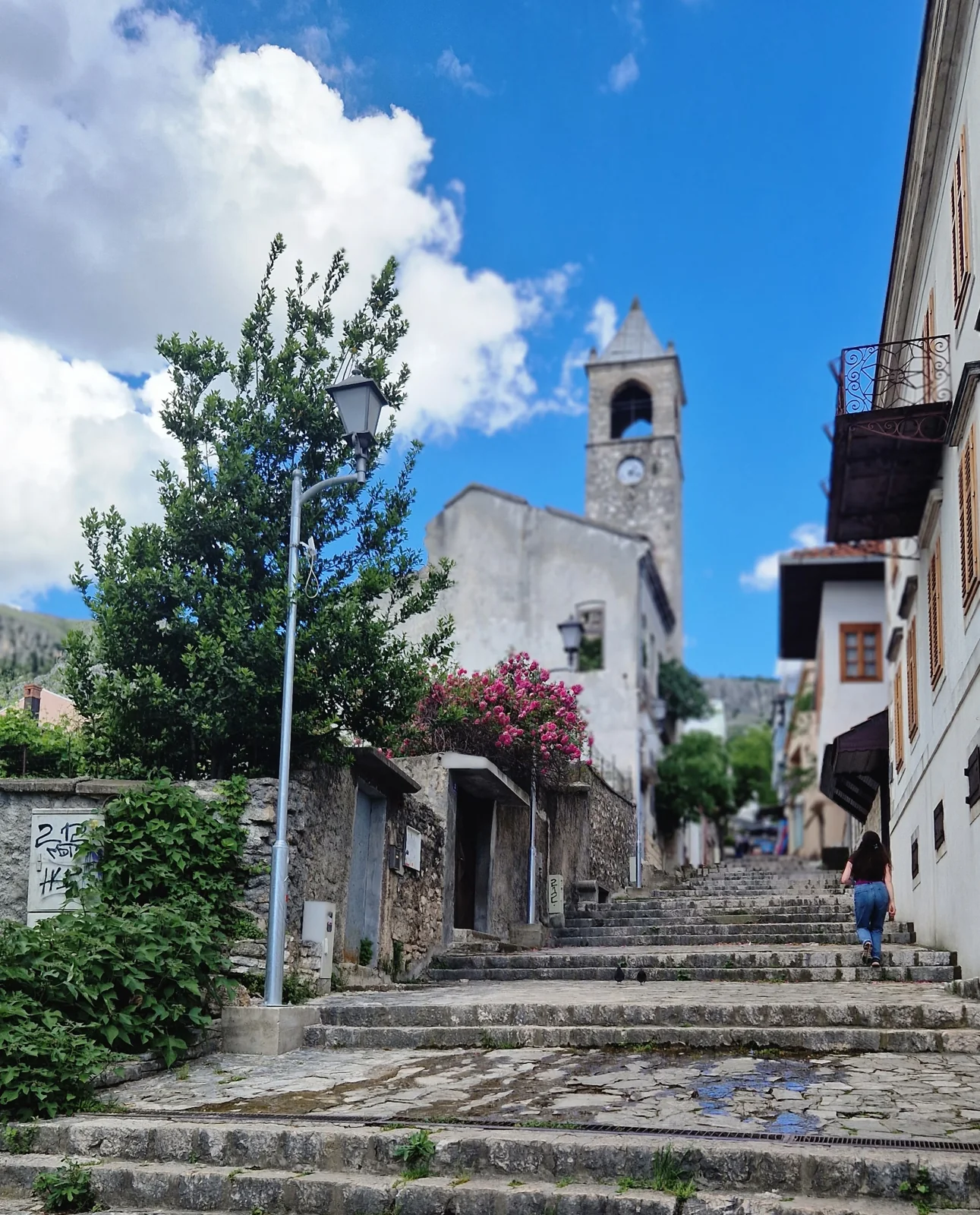 Historic clock tower and street setting in Mostar
