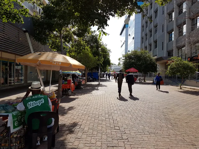 Pedestrian shopping area and trees at Main Mall in central Gaborone