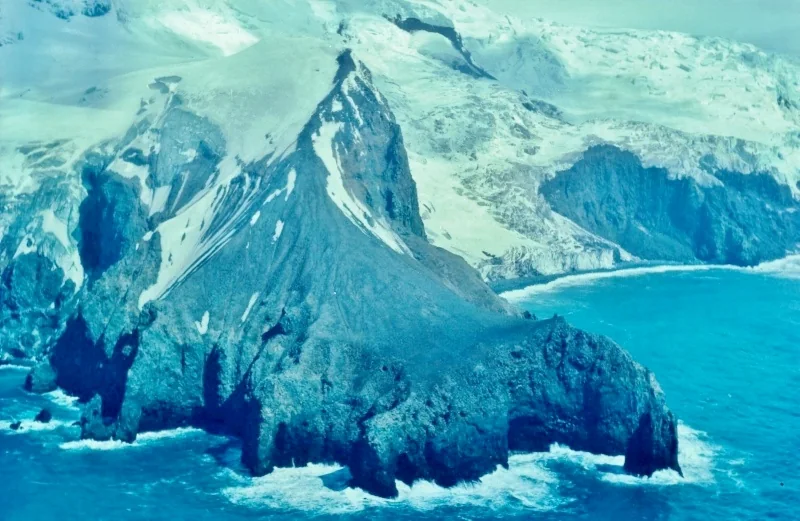Snow and dark coastal rocks at Cape Valdivia on Bouvet Island