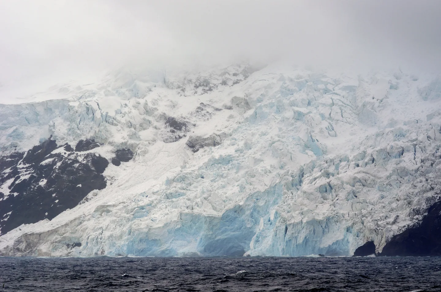 Steep ice-covered west coast of Bouvet Island seen from a ship