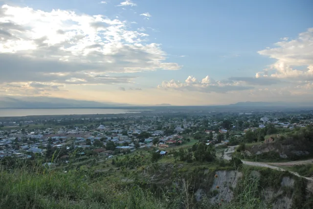 Bujumbura and Lake Tanganyika below green hills in an elevated city view