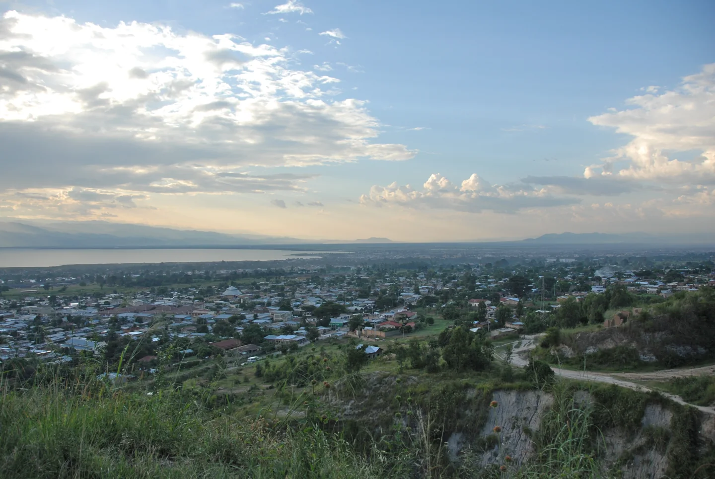 Bujumbura and Lake Tanganyika below green hills in an elevated city view