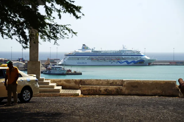 Praia harbour with a cruise ship, waterfront and taxi in the foreground