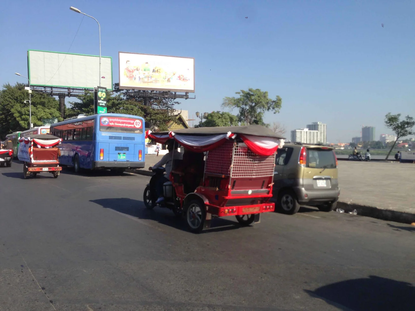A city bus and tuk-tuks near Phnom Penh’s Night Market terminus