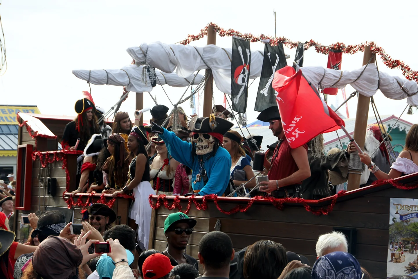 Pirate ship parade float and spectators at Pirates Week in George Town