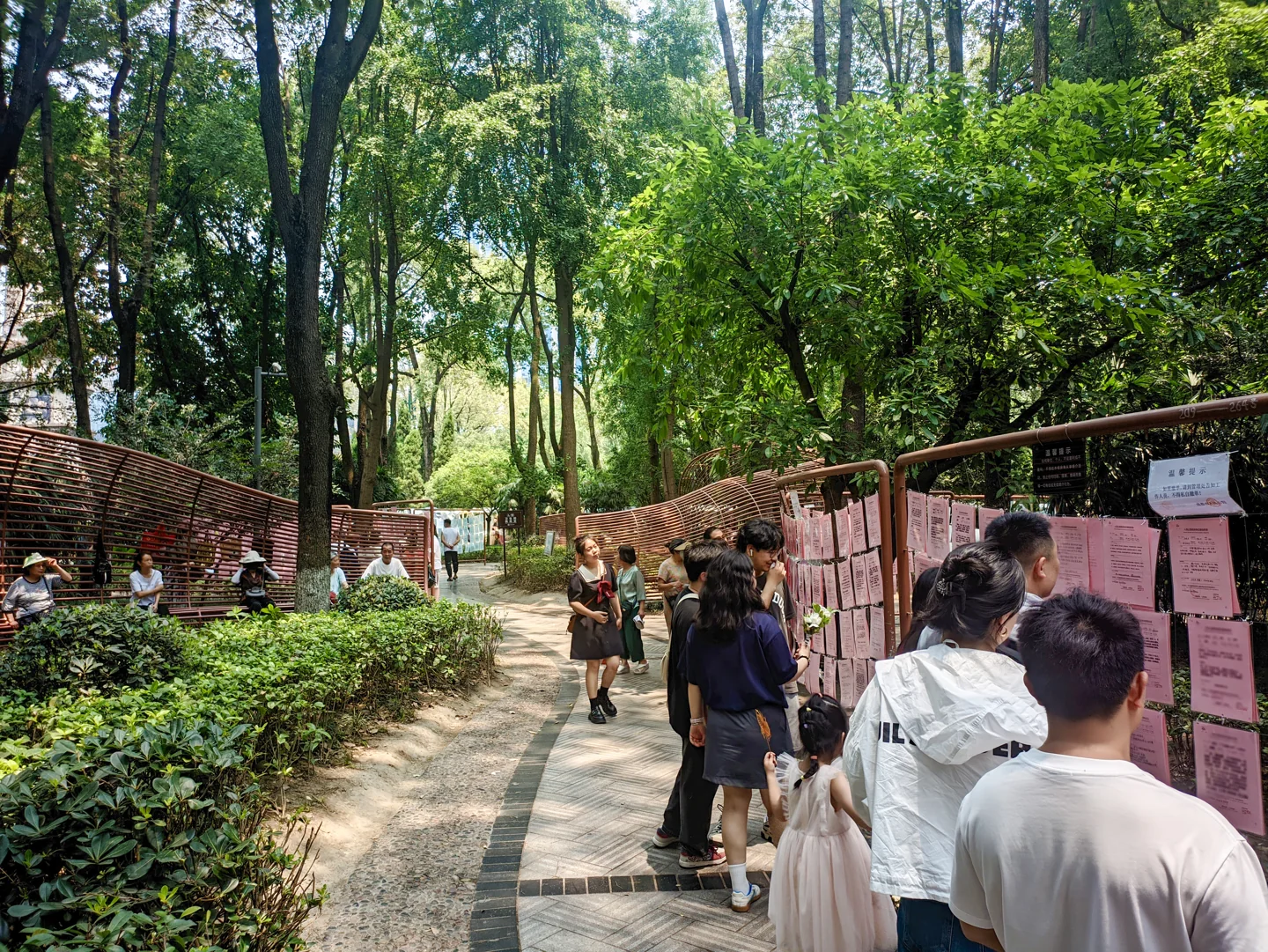 People and information displays at the matchmaking corner of People's Park in Chengdu