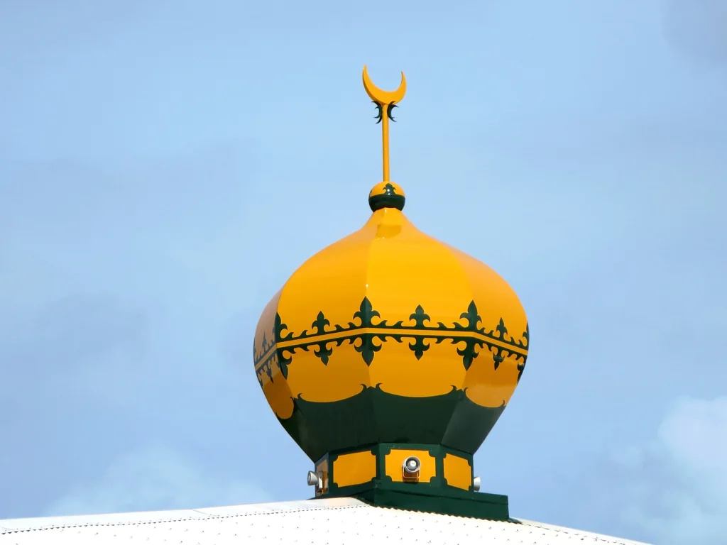 The yellow mosque dome with green decoration on Home Island