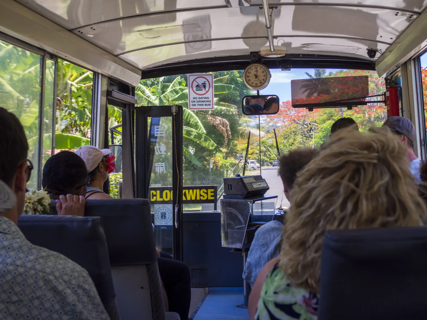 Passengers, seats and the front view inside a Rarotonga bus