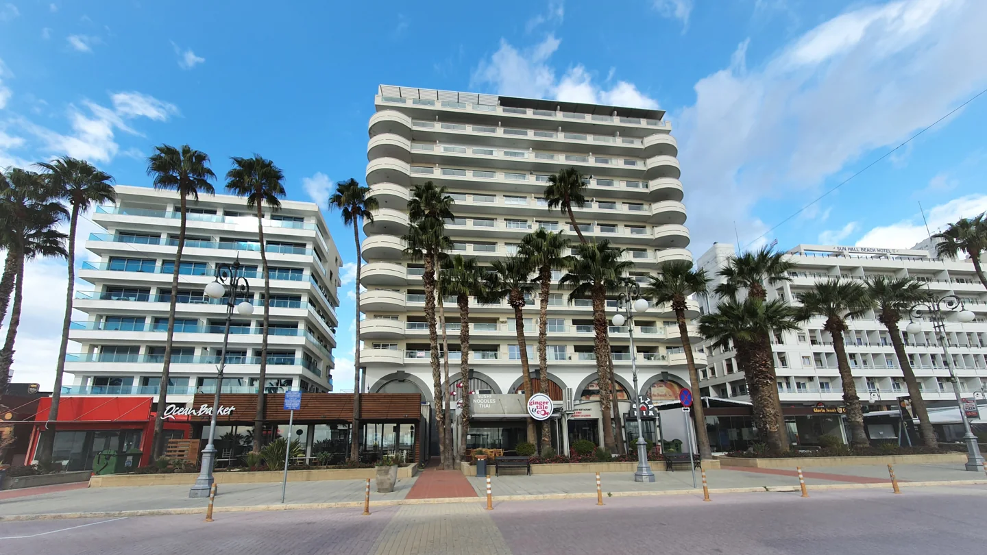 Palm trees and hotel façades along the Phinikoudes seafront road in Larnaca