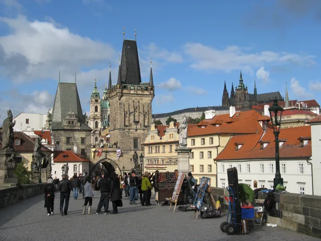 Pedestrians on Prague’s Charles Bridge with its historic bridge towers