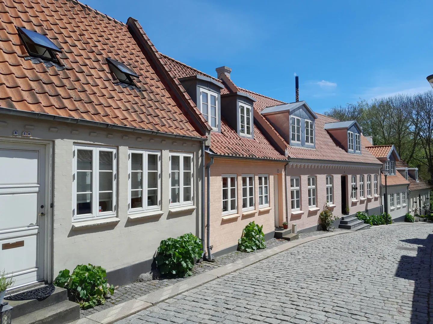 An old street with low colourful buildings in central Odense
