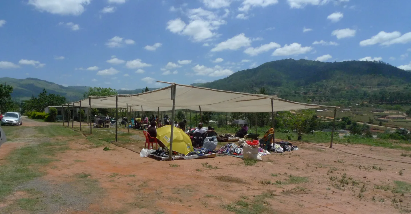 Traders and clothing stalls at an outdoor market in Ezulwini