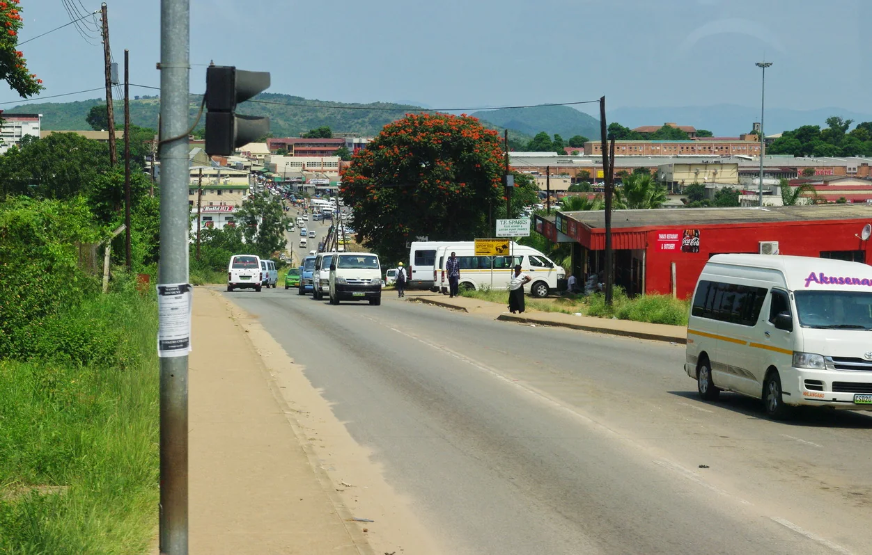 Road approaching Manzini with buildings and traffic