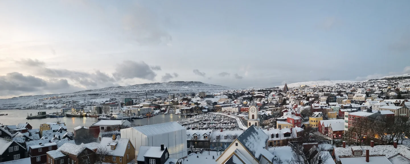 Snow-covered Tórshavn town and harbour on a December morning